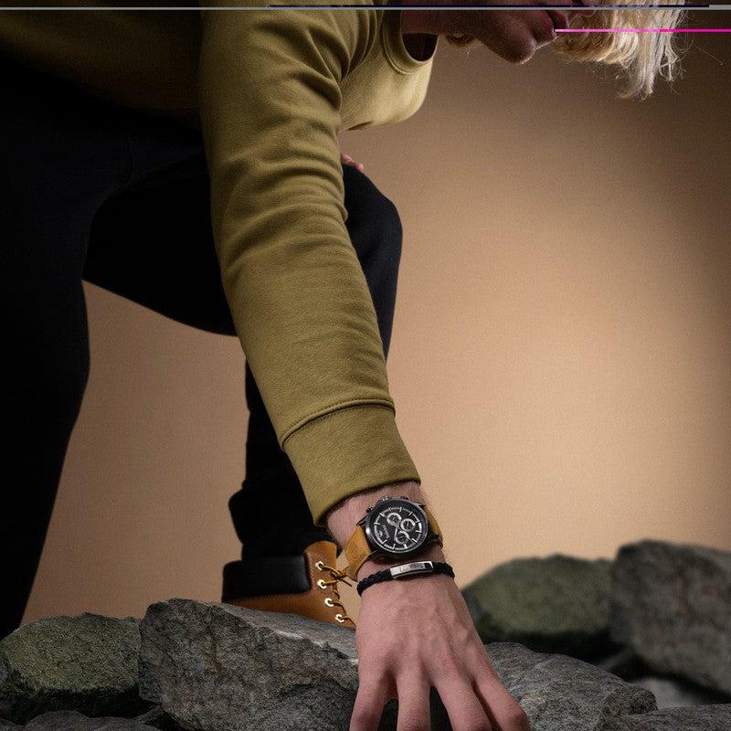 Timberland Hampton Harbour 46mm watch with a black dial and coffee brown leather strap on a wrist.