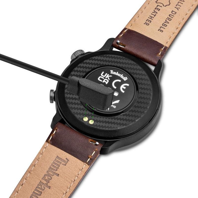 Timberland Trail Force smartwatch with a brown leather strap, featuring magnetic charging on its sleek black case back.
